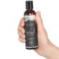 Intimate Earth Naked Massage Olie 120 ml Produktbillede med hånd 50
